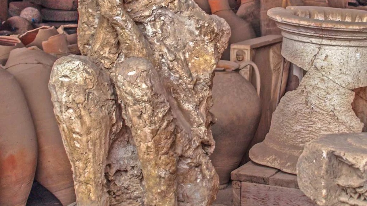 a group of teddy bears sitting next to a statue