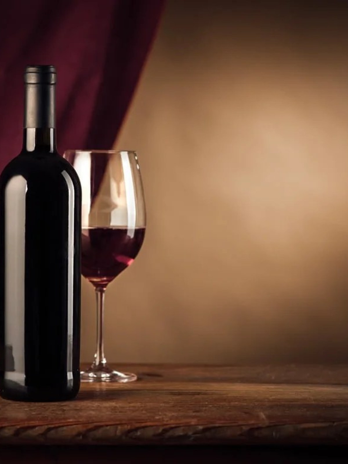 a bottle of wine sitting on top of a wooden table