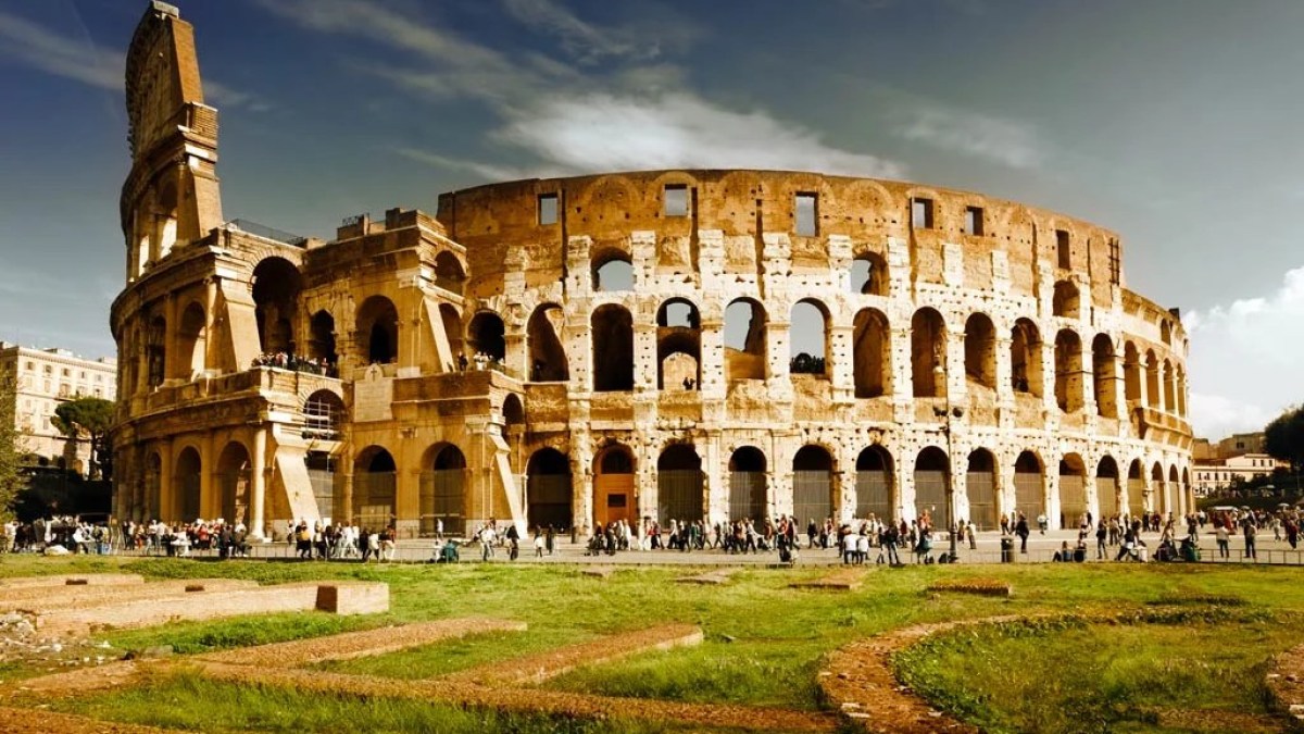 a large stone building with Colosseum in the background