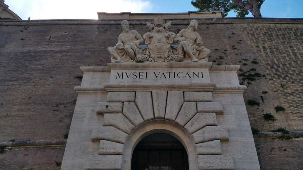 a large stone statue in front of a brick building